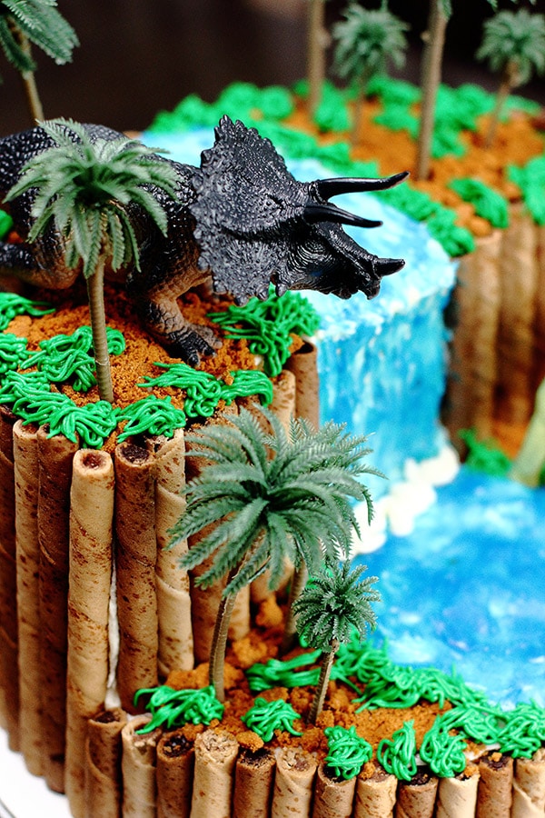 angled view of a 3D dinosaur cliff and waterfall cake