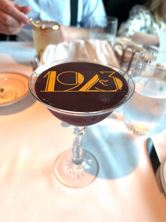 the Buena Vista Boulevardier cocktail with chocolate disc topper from the 1923 restaurant on the Disney Wish