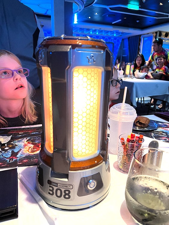 a glowing replica Quantum Core on a table in Worlds of Marvel on the Disney Wish
