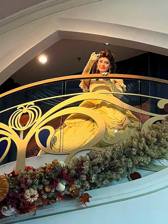 Belle waving from the Juliet balcony on the Disney Wish