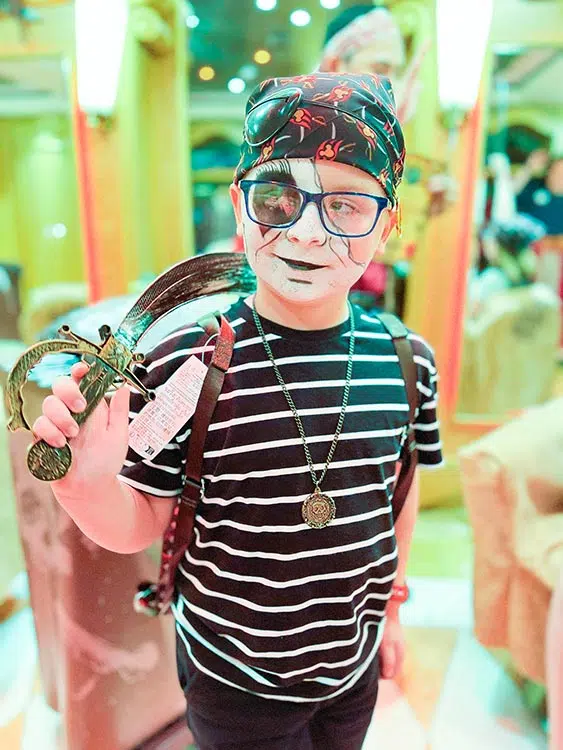 a boy dressed up like a zombie pirate on a Disney cruise