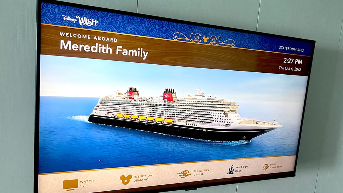 TV screen showing the Disney Wish cruise ship reading "Welcome aboard Meredith family"