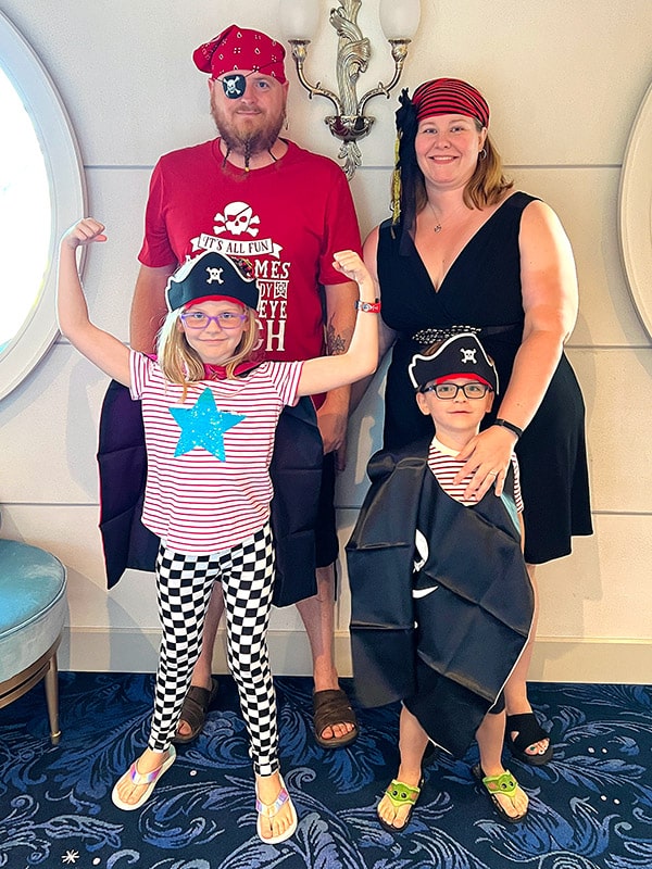a family of four dressed up for Pirate Night on the Disney Wish