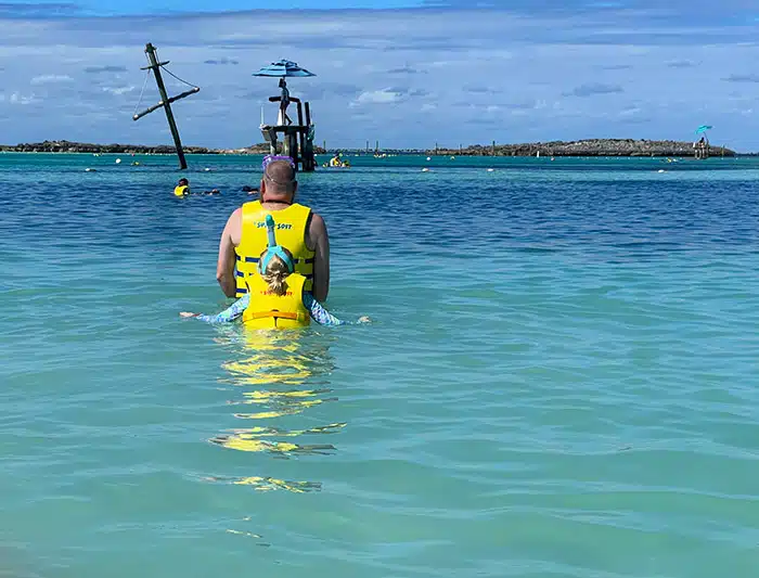 father-daughter snorkeling duo walking out into the water