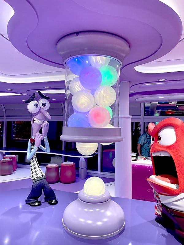 photo of decor in Inside Out: Joyful Sweets featuring Fear and Anger next to a tube of memory orbs
