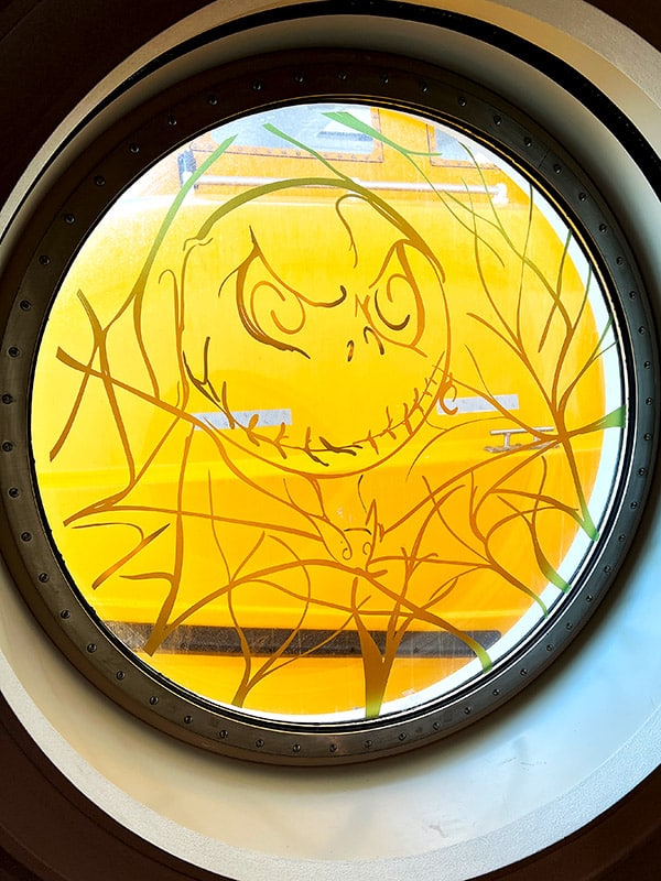 line art of Jack Skellington on a porthole window on the Disney Wish