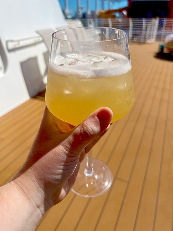 a hand holding up a Kentucky Lemonade cocktail