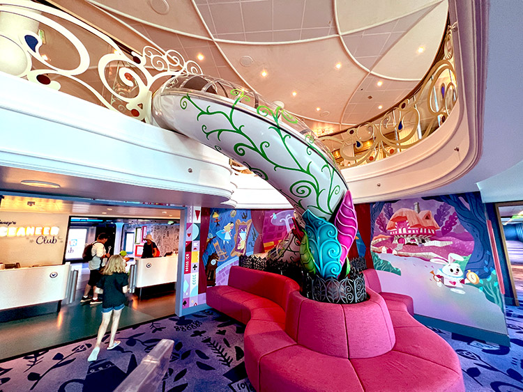 wide view of the Alice in Wonderland-themed slide that goes to the Oceaneer Club on Disney Wish