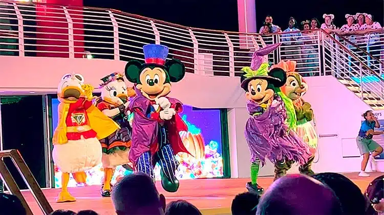 a photo taken during the Mickey's Mouse-querade show on a Disney Wish Halloween on the High Seas cruise