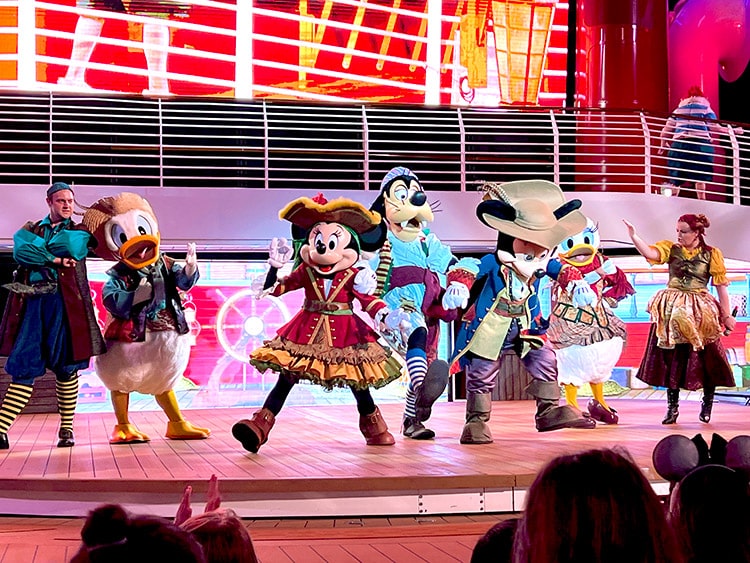 Mickey, Minnie, Donald, Daisy, and Goofy dancing at Mickey's Pirates in the Caribbean Party