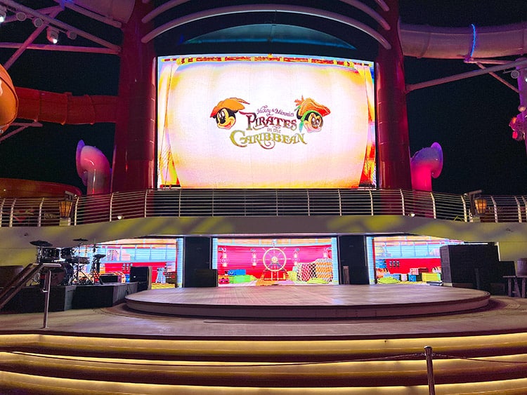wide shot of the screens, including Funnel Vision, on the Disney Wish before Mickey's Pirates in the Caribbean starts