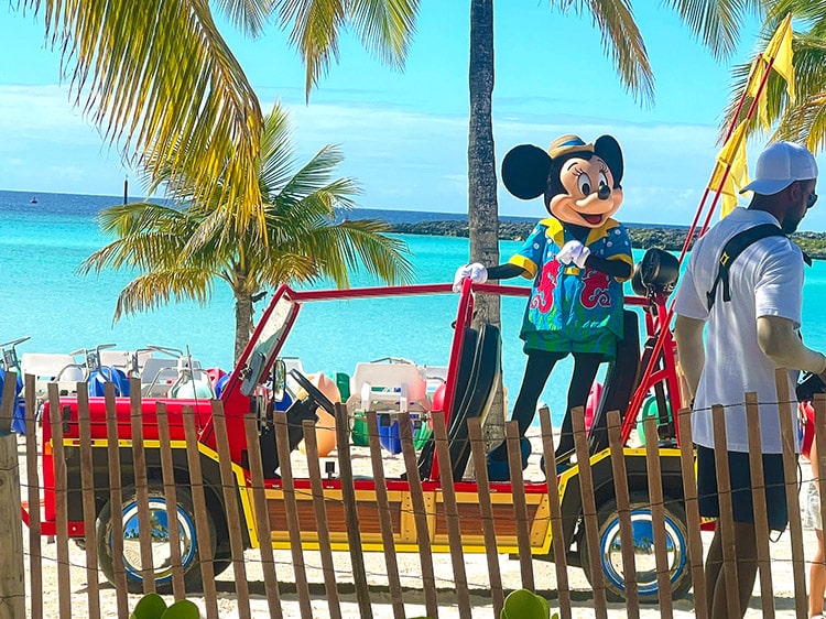 Minnie Mouse in her island outfit standing in a car on Castaway Cay