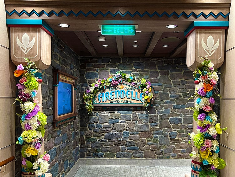 the Arendelle sign and columns on Disney Wish covered in summer flowers