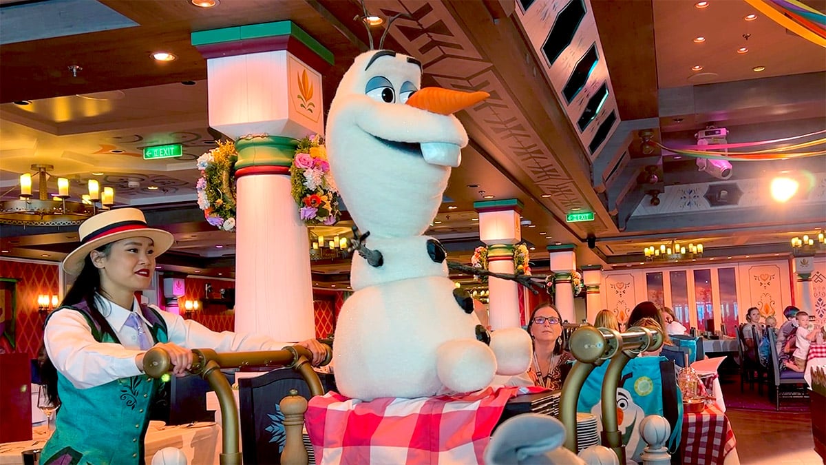 an animatronic Olaf sitting on a serving cart on the Disney Wish