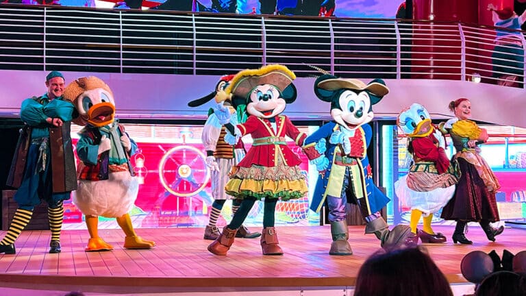 photo of Mickey, Minnie, Donald, Daisy, and Goofy dressed as pirates and performing at Mickey's Pirates in the Caribbean Party on the Disney Wish