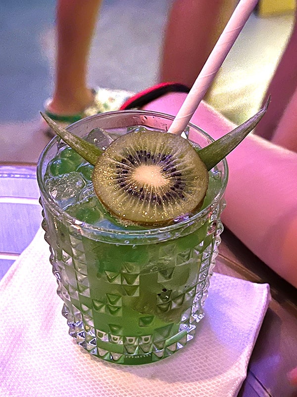 the Temple Twist mocktail from Hyperspace Lounge, a green non-alcoholic drink with a kiwi and leaves arranged on top to resemble Yoda