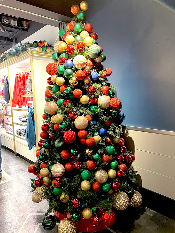 a Christmas tree full of ball ornaments in the Empire State Building gift shop in NYC