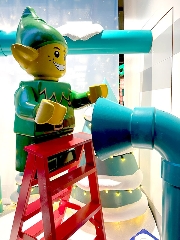 a giant LEGO elf in a window display at the LEGO Store on Fifth Avenue in NYC