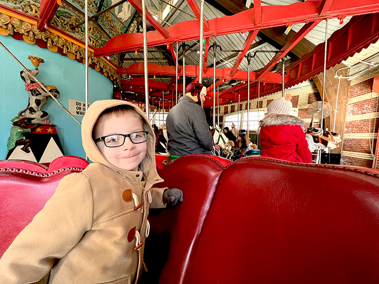 a family riding the Central Park Carousel in winter