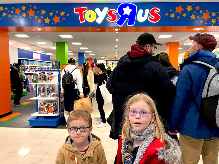 a boy and girl reacting to seeing a Toys 'R' Us for the first time in Macy's in New York City