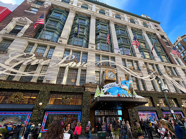 a wide view of the front of Macy's in Herald Square at Christmas time