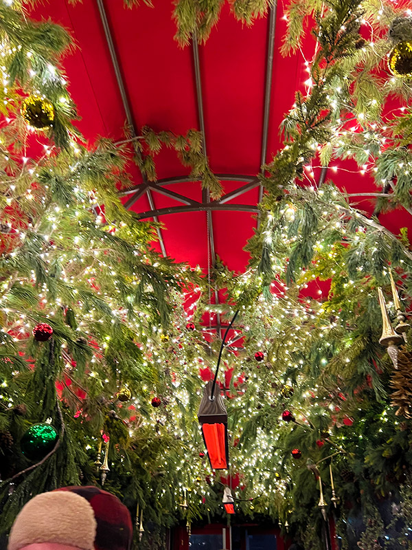 Christmas lights and garland hanging in the covered entry to Tavern on the Green