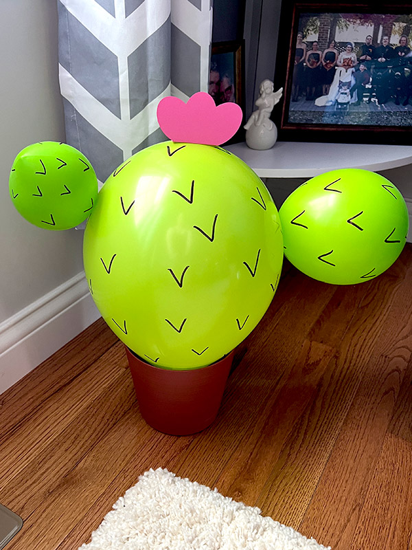 a cactus made out of balloons in a planter