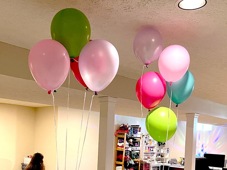 floating party balloons in Encanto themed colors