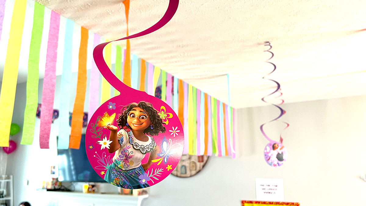 a hanging spiral featuring Mirabel from Encanto with colorful streamers in the background