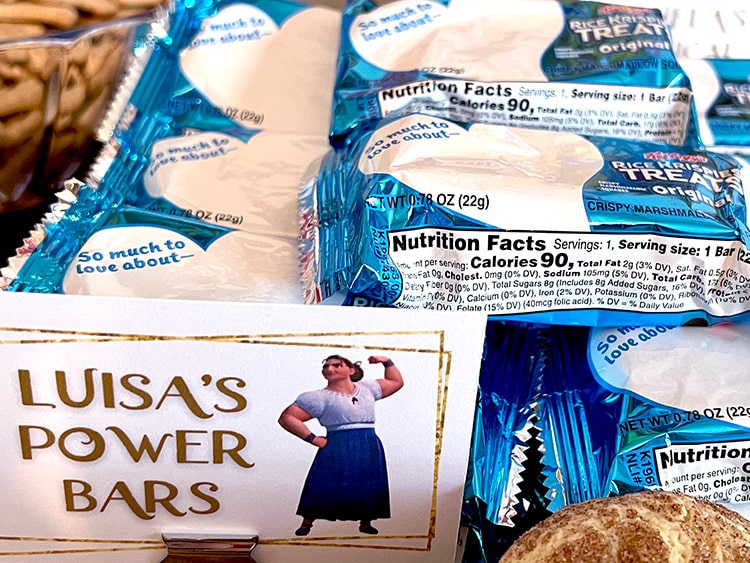 a tray of wrapped Rice Krispie treats with a card featuring Luisa from Encanto and the text "Luisa's Power Bars"