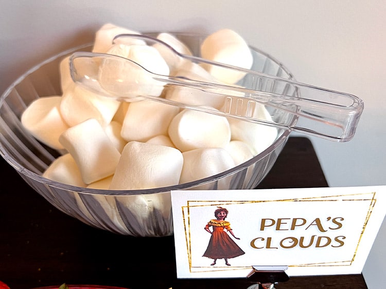 bowl of giant marshmallows and a card featuring Pepa from Encanto that reads "Pepa's clouds"