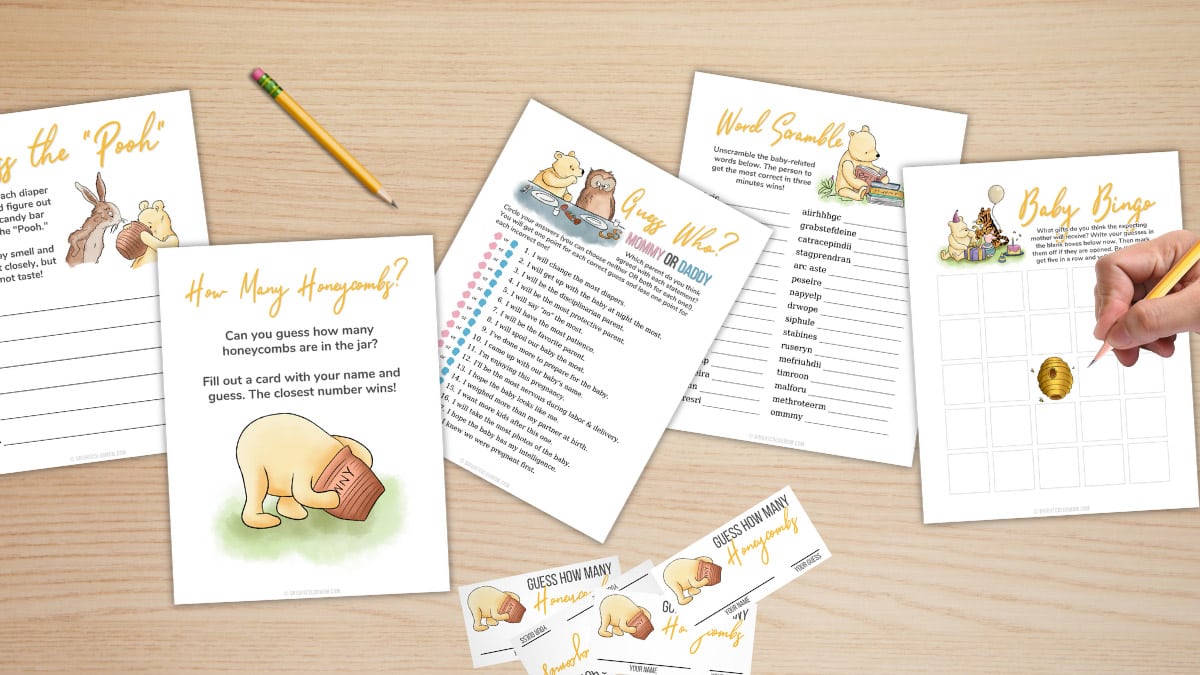 several printed baby shower games scattered on a table, all themed to the classic Winnie the Pooh illustrations