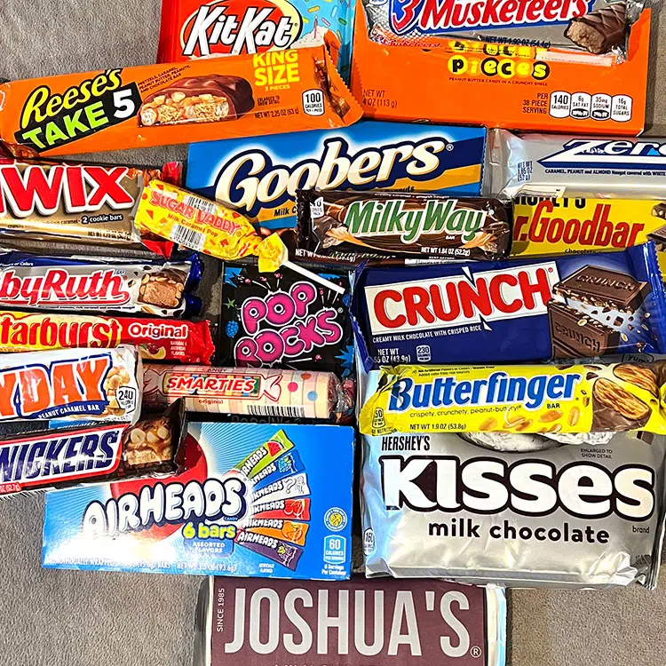 a pile of various candy bars and boxes