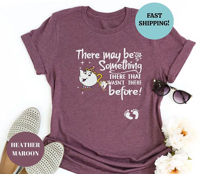 maroon shirt featuring Mrs. Potts and Chip from Beauty and the Beast with the text "There may be something there that wasn't there before!" and baby footprints at the belly