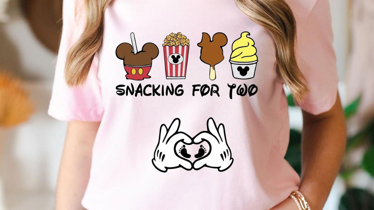a Disney themed pregnancy announcement shirt featuring park snacks