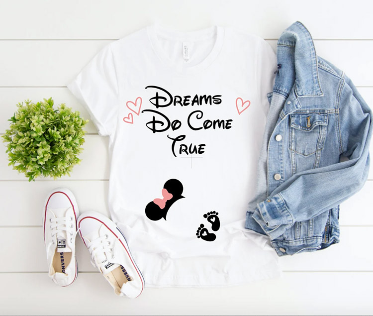 white shirt with "Dreams Do Come True" on the chest and Minnie mouse ears with baby footprints at the belly