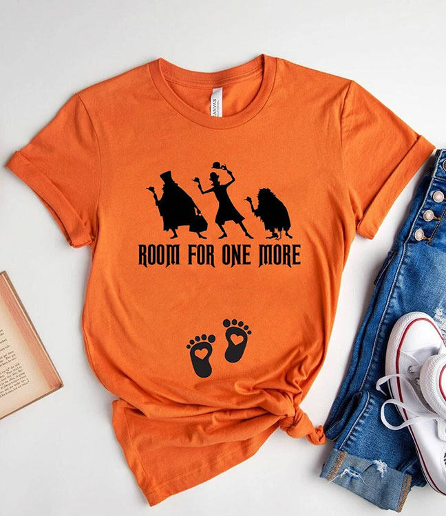 orange shirt with silhouettes of the hitchhiking ghosts from Haunted Mansion and the text "Room for One More" and baby footprints at the belly