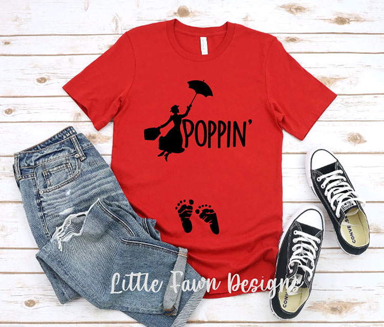 red shirt featuring a silhouette of Mary Poppins and the text "Poppin'" with baby footprints at the belly