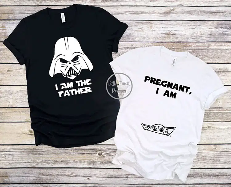 pair of coordinating pregnancy t-shirts with the father's shirt in black featuring Darth Vader from Star Wars and the text "I am the Father" while the mom's shirt is white with the text "Pregnant, I am" and a baby yoda peeking out near the belly area