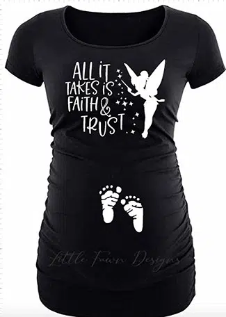 black maternity shirt featuring white HTV showing baby feet on the stomach and Tinker Bell on the chest with "All it takes is Faith & Trust" next to her