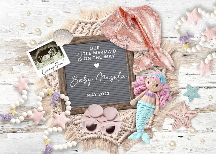 a flat lay of white, beige, and pink tones featuring various mermaid and baby-related items with a letterboard in the center that says "Our little mermaid is on the way!"
