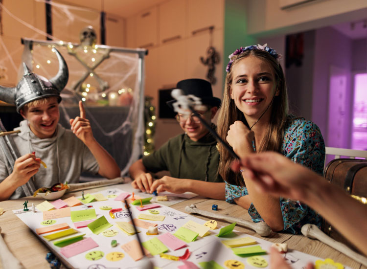 teenage siblings playing a board game on New Year's Eve