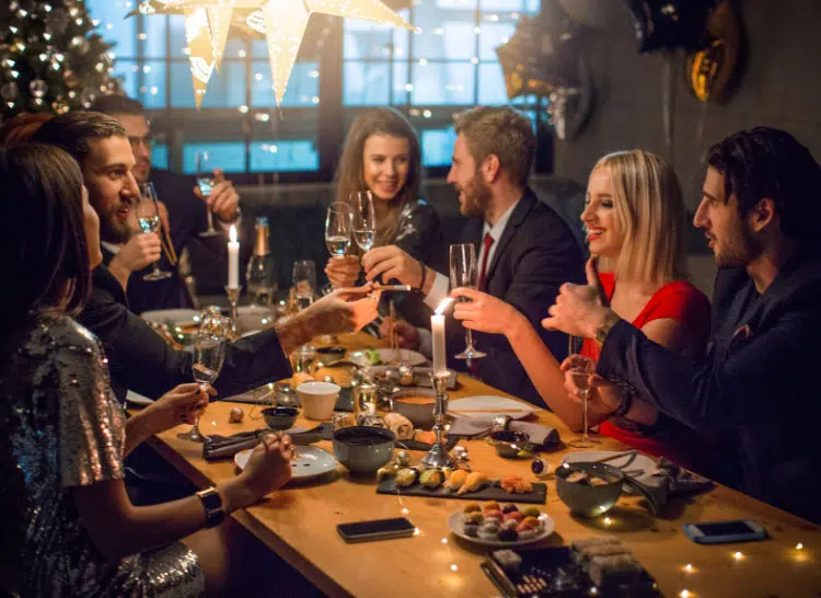 several couples seated around a table for a New Year's Eve party