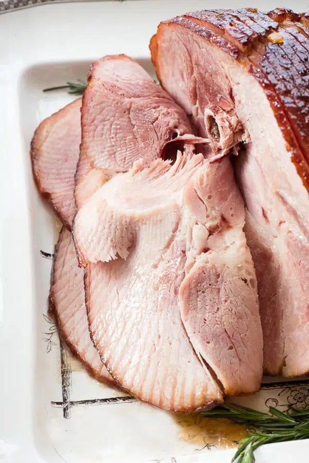 a cooked spiral ham on a white platter