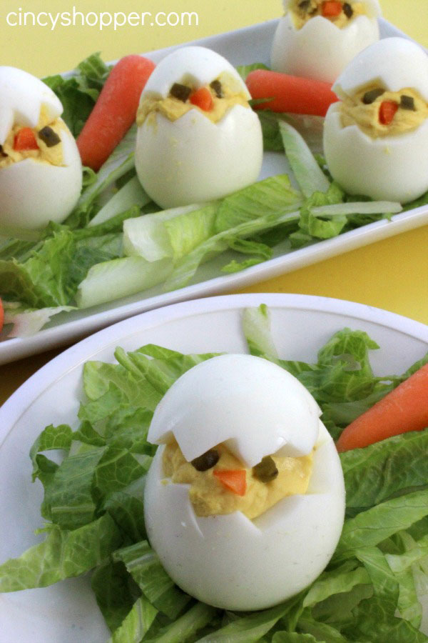 deviled eggs sitting vertically made to look like baby chicks hatching from the eggs