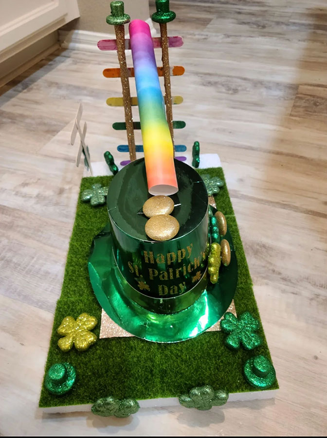 a leprechaun trap made out of a green top hat with a rainbow chute