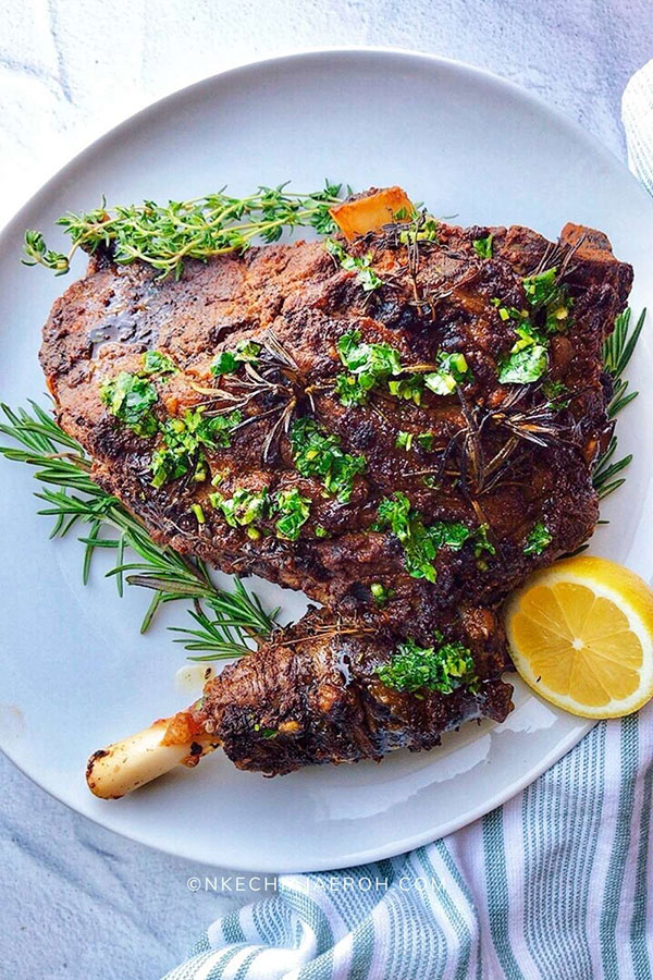 a cooked leg of lamb on a round white platter