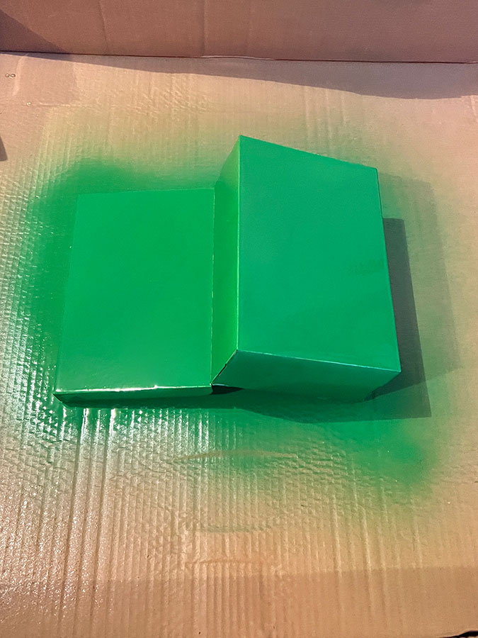 a hinge-lidded shoebox spray painted green