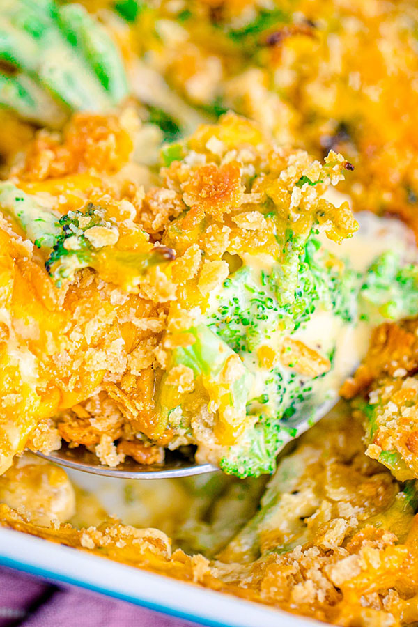 a lifted spoonful of broccoli cheese casserole