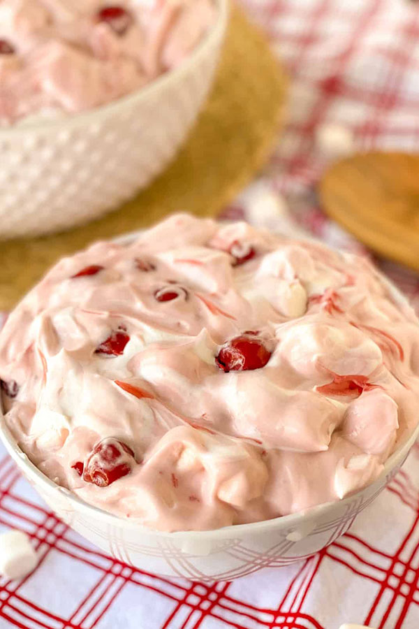 cherry cheesecake marshmallow fluff dessert in a white bowl on a table
